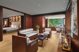 a living room with a couch and a bed at Tonino Lamborghini Hotel Suzhou in Suzhou