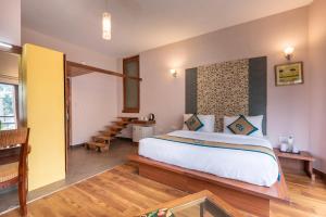 a bedroom with a large bed in a room at Spring Valley Resorts by DLS Hotels in McLeod Ganj