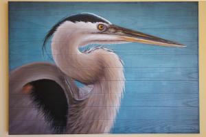 a painting of a pelican on a blue background at Tidewater 1202 condo in Orange Beach