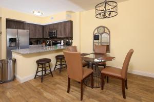 a kitchen and dining room with a table and chairs at Tidewater 1202 condo in Orange Beach