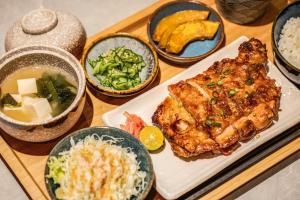 a tray of food with meat and other foods on it at Hayata Hotel in Hengchun South Gate