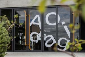 a glass door of a store with asale sign on it at 緩慢大鵬灣 in Donggang