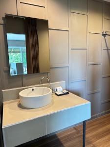 a bathroom with a white sink and a mirror at HIP Seaview Resort @ Phi Phi in Phi Phi Don