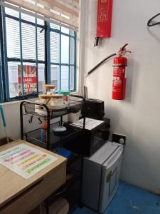 an office with a fire extinguisher hanging on the wall at Room 1 (Super single: 1 pax) in Kampong Kiarong