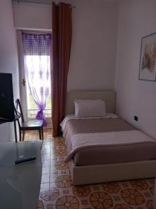 Postel nebo postele na pokoji v ubytování Il Brindisi di C & C Castelli Romani