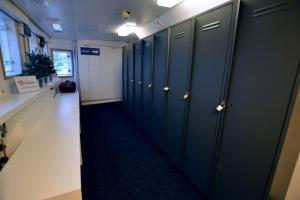 a hallway with green lockers in an office building at Hotellilaiva Muikku/Hotel Boat Muikku in Helsinki