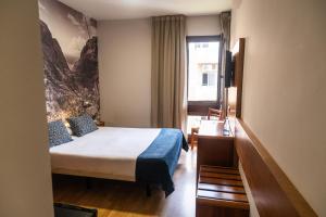 a hotel room with a bed and a window at Hotel Adonis Plaza in Santa Cruz de Tenerife