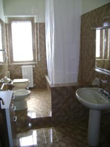 a bathroom with two sinks and two toilets at Torrebianca in Erice
