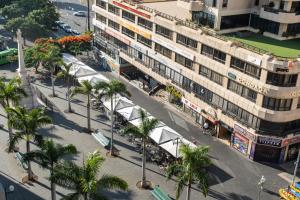 an overhead view of a street with palm trees and a building at Hotel Adonis Plaza in Santa Cruz de Tenerife