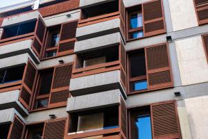 an apartment building with brown window shutters at Hotel Adonis Plaza in Santa Cruz de Tenerife