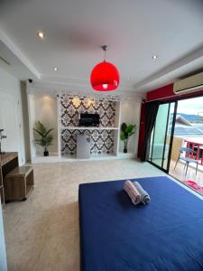 a bedroom with a blue bed and a fireplace at Petunya Phuket Guest House in Ban Huai Luk (1)