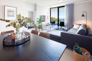 a living room with a table and a couch at The Tyne Luxury Apartments in Durban