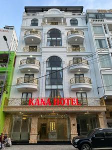 a white building with a koma hotel sign on it at Kana Hotel Nha Trang in Nha Trang