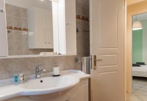 a bathroom with a sink and a mirror at Gtrip Ellinikon Experience Apartment - 31506 in Athens