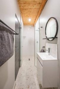 a bathroom with a sink and a mirror and a shower at Eikenhof Estate in Brackenfell