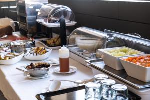 a buffet line with a lot of food on it at Hotel Adonis Plaza in Santa Cruz de Tenerife
