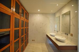 baño con 2 lavabos y espejo grande en Shankara Munduk Bali, en Munduk