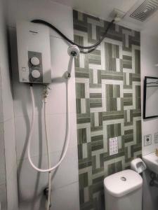 a shower in a bathroom with a toilet at S and M Hotel Inc. in Cebu City