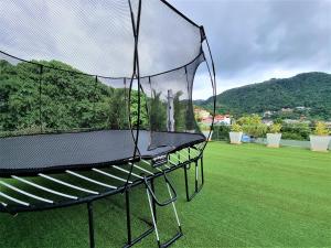 a batting cage in a yard with a green lawn at Q Kata Residence in Kata Beach
