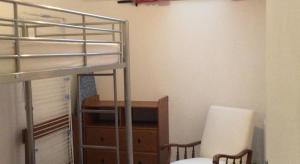 a bedroom with a bunk bed with a desk and a chair at Au Coeur de Bourg CSM in Courseulles-sur-Mer