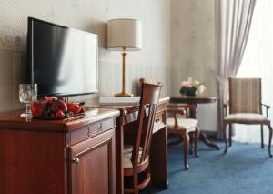 a hotel room with a television on a desk with a bowl of fruit at Continental Hotel in Odesa