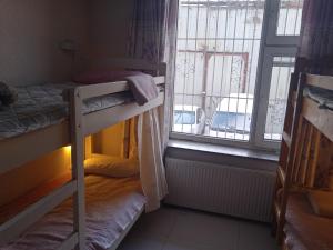 a room with two bunk beds and a window at Bolod Guesthouse and Tours in Ulaanbaatar