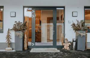a teddy bear sitting in front of a door at Bucheggerhof in Schladming