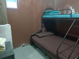 a small room with two bunk beds in it at Deena Homestay in Ranau