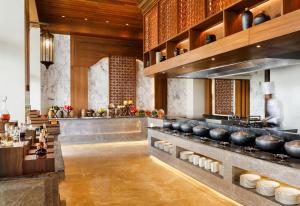 a kitchen with a counter with bowls and plates at Dusit Thani Himalayan Resort Dhulikhel, Nepal in Dhulikhel
