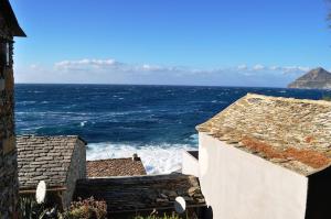 a view of the ocean from between two buildings at CABANON TIMANTHE in Canari +11 photos