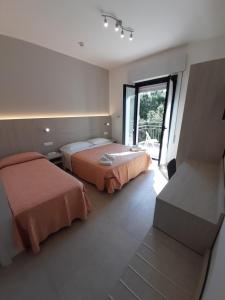Postel nebo postele na pokoji v ubytování Hotel Altamarea