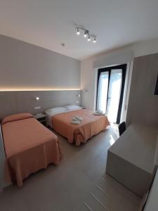 Postel nebo postele na pokoji v ubytování Hotel Altamarea