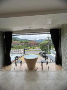 a large room with a large tub and two chairs at Petunya Phuket Guest House in Ban Huai Luk (1)