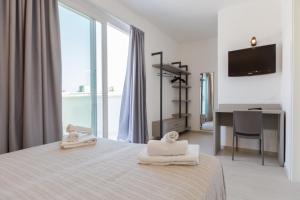 Postel nebo postele na pokoji v ubytování Hotel Altamarea