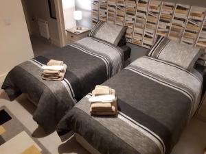 two beds in a room with towels on them at SWIFT HALF in Ballyconnell