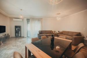 a living room with a couch and a table at Theasis Luxury Apartment in Nafplio