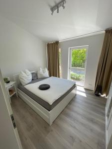 a bedroom with a bed and a large window at Quartier am Haff in Ueckermünde