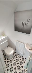 a bathroom with a white toilet and a sink at Guest suite 50m from the beach in Bognor Regis