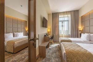 Postel nebo postele na pokoji v ubytování Hayasa Hotel Yerevan