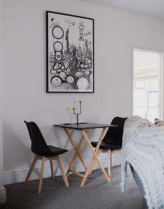 a dining room with a table and two chairs at No. 82 Grade II Listed Norwich City Centre Flat in Norwich