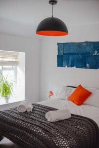 a bedroom with a bed with two towels on it at No. 82 Grade II Listed Norwich City Centre Flat in Norwich