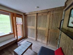 a living room with wooden walls and a window at HSL in Valmorel