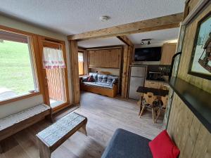 a kitchen and living room in a log cabin at HSL in Valmorel