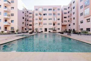 une piscine en face d'un bâtiment dans l'établissement Appartement résidence Marrakech haut standing piscine, à Marrakech