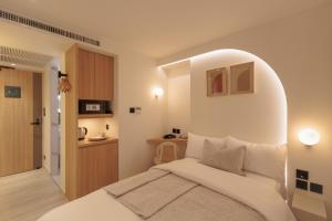 a bedroom with a white bed with an arch above it at CORRIDOR 2407 in Bangkok