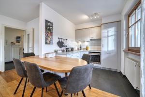 a kitchen with a wooden table and chairs at FaWa Apartments "Family" in Brunico