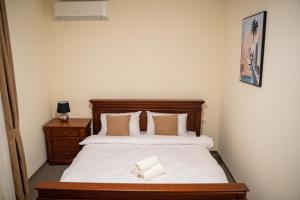 a bedroom with a large bed with a wooden headboard at Motel Zeta Lux in Mitrovići