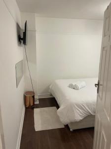 a small bedroom with a bed and a small door at Spare room in a family house in Bristol