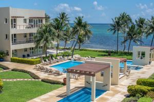 an aerial view of a resort with a swimming pool and the ocean at The Phoenix Resort in San Pedro