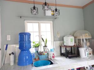 a kitchen counter with a sink and a window at Bohol-Simple and Elegant Suite in Tagbilaran City